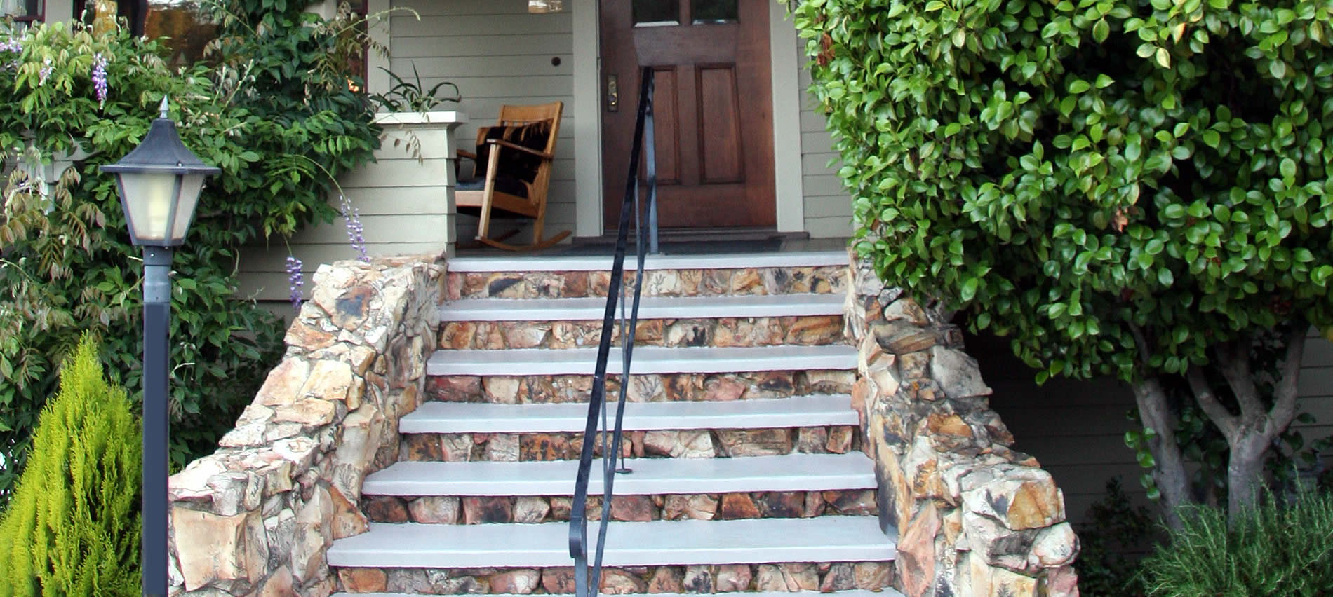 about eureka street inn and the stone steps that lead to the expansive sitting porch
